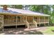 Charming one story stone-clad home featuring a wooden porch and front door, set in a forested lot at 257 Martin Ln, Canton, GA 30114