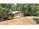 A detached garage with stone facade and two garage doors, set in a wooded lot at 257 Martin Ln, Canton, GA 30114