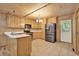 Well-lit kitchen boasts tile floors, stainless steel appliances, wood cabinetry and a bright chandelier at 257 Martin Ln, Canton, GA 30114
