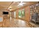 Spacious living room with wood floors, wood-paneled walls, and stone fireplace at 257 Martin Ln, Canton, GA 30114