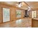 Open-concept space with wood floors, wood-paneled walls, and stone fireplace at 257 Martin Ln, Canton, GA 30114