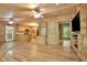 Open-concept living space featuring wood floors, wood-paneled walls, and a view into the kitchen at 257 Martin Ln, Canton, GA 30114
