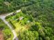 A high angle aerial view showing the home, expansive green lawn, and road at 4380 Highway 138, Oxford, GA 30054