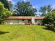 View of the back of the house with a large lawn and a small patio area at 4380 Highway 138, Oxford, GA 30054
