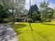 Single-story home with a long driveway, attached garage, and a well-maintained lawn at 4380 Highway 138, Oxford, GA 30054