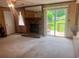 Cozy living room with a brick fireplace and sliding glass doors leading to the backyard at 4380 Highway 138, Oxford, GA 30054