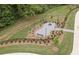 Aerial view of a neighborhood fire pit area with benches and walking paths at 4835 Wayt Farm Overlook, Cumming, GA 30040