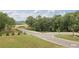 Street view within the neighborhood surrounded by green spaces and trees at 4835 Wayt Farm Overlook, Cumming, GA 30040