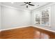 Bright bedroom with hardwood floors, large window offering natural light, and neutral wall color at 7160 Fawn Lake Dr, Alpharetta, GA 30005
