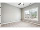 Bedroom with carpet, ceiling fan, and a window offering natural light at 7160 Fawn Lake Dr, Alpharetta, GA 30005