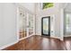 Sunlit foyer featuring glass paneled office doors, and hardwood flooring at 7160 Fawn Lake Dr, Alpharetta, GA 30005