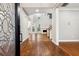 Inviting foyer featuring hardwood floors, high ceilings, staircase, and seamless transition into the living area at 7160 Fawn Lake Dr, Alpharetta, GA 30005