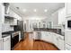 Spacious open kitchen with stainless steel appliances and granite countertops at 7160 Fawn Lake Dr, Alpharetta, GA 30005