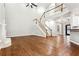 Spacious living area featuring hardwood floors, fireplace, high ceilings, and staircase to the upper level at 7160 Fawn Lake Dr, Alpharetta, GA 30005