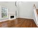 Bright living room featuring hardwood floors, fireplace, staircase, and large windows for natural light at 7160 Fawn Lake Dr, Alpharetta, GA 30005