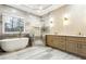 Luxurious bathroom featuring a soaking tub, shower, and double vanity at 7160 Fawn Lake Dr, Alpharetta, GA 30005