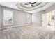 Spacious main bedroom with a tray ceiling and a view to the ensuite bathroom at 7160 Fawn Lake Dr, Alpharetta, GA 30005