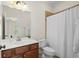 Bathroom featuring a vanity with wood cabinets, mirror and shower with white curtain at 1215 Renaissance Se Ct, Mableton, GA 30126