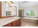 The bathroom features tile floors, cherry cabinets, granite counters, and a separate tub and shower at 1215 Renaissance Se Ct, Mableton, GA 30126