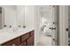 Modern bathroom vanity with wood cabinets and bright view of the connected bedroom at 1215 Renaissance Se Ct, Mableton, GA 30126