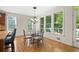 Sunlit breakfast area with hardwood floors and large windows overlooking the backyard at 1215 Renaissance Se Ct, Mableton, GA 30126