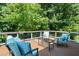 Relax on this wooden deck, complete with outdoor seating and a serene natural backdrop at 1215 Renaissance Se Ct, Mableton, GA 30126