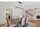Dining room features modern light fixture, wainscotting, and hardwood floors at 1215 Renaissance Se Ct, Mableton, GA 30126