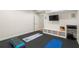 Bright fitness room with black floor mats, and storage with audio components at 1215 Renaissance Se Ct, Mableton, GA 30126
