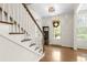 Bright foyer features hardwood floors, staircase, and view of entry with sidelights at 1215 Renaissance Se Ct, Mableton, GA 30126