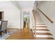Open hallway with hardwood floors leads to staircase and other rooms at 1215 Renaissance Se Ct, Mableton, GA 30126