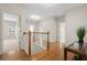 This hallway showcases hardwood floors, white walls and doors, and view to staircase and bedroom at 1215 Renaissance Se Ct, Mableton, GA 30126