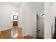 Hallway displaying hardwood floors leading to the stairwell and a bathroom with a vanity at 1215 Renaissance Se Ct, Mableton, GA 30126