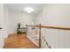 This hallway features hardwood floors, white walls, and a staircase with white and wood rails at 1215 Renaissance Se Ct, Mableton, GA 30126