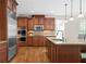 Gourmet kitchen featuring stainless steel appliances, custom cabinets, and a tile backsplash at 1215 Renaissance Se Ct, Mableton, GA 30126
