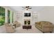 Bright living room featuring a fireplace, built-in bookshelves, and large windows at 1215 Renaissance Se Ct, Mableton, GA 30126