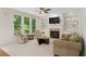 Cozy living room with a fireplace, custom built-ins, and plenty of natural light at 1215 Renaissance Se Ct, Mableton, GA 30126