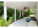 Relaxing covered patio area with comfortable seating surrounded by greenery at 1215 Renaissance Se Ct, Mableton, GA 30126