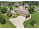 Aerial view of a home showcasing its three-car garage, mature trees, and well-maintained landscaping at 2602 Alcovy Club Dr, Dacula, GA 30019