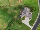 Aerial shot of home with a large lawn, mature trees, and a spacious driveway at 2602 Alcovy Club Dr, Dacula, GA 30019
