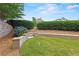 Backyard with brick retaining wall, lovely shrubs, terraced landscaping and access stairs at 2602 Alcovy Club Dr, Dacula, GA 30019
