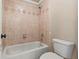 Full bathroom with a tiled shower and a toilet with tan colored walls at 2602 Alcovy Club Dr, Dacula, GA 30019