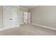 Neutral carpeted room with closet space, a door and a view to another room at 2602 Alcovy Club Dr, Dacula, GA 30019