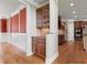 Butler's pantry area with granite countertop, tile backsplash, and view into the kitchen at 2602 Alcovy Club Dr, Dacula, GA 30019