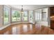 Bright dining room with hardwood floors, bay windows, and access to outdoor area, next to a carpeted living room at 2602 Alcovy Club Dr, Dacula, GA 30019