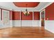 Formal dining room with hardwood floors, crown molding, and stylish chandelier at 2602 Alcovy Club Dr, Dacula, GA 30019