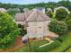 Stunning brick home with manicured landscaping, mature trees, and an inviting entrance at 2602 Alcovy Club Dr, Dacula, GA 30019