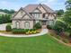 Beautiful brick home with manicured lawn, mature trees, and meticulous landscaping at 2602 Alcovy Club Dr, Dacula, GA 30019