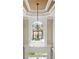 Elegant chandelier and foyer with a grand staircase at 2602 Alcovy Club Dr, Dacula, GA 30019