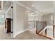 Hallway with carpet flooring, iron banister, and coffered ceilings in neutral decor at 2602 Alcovy Club Dr, Dacula, GA 30019
