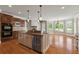 Gourmet kitchen featuring an island, wooden cabinets, granite countertops, and stainless-steel appliances at 2602 Alcovy Club Dr, Dacula, GA 30019